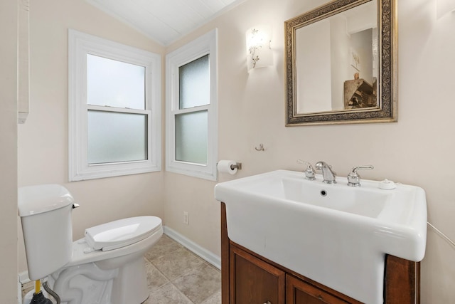 bathroom featuring tile patterned floors, vanity, toilet, and lofted ceiling