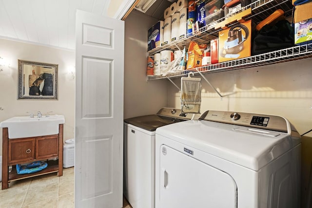 clothes washing area with separate washer and dryer, sink, light tile patterned floors, and ornamental molding