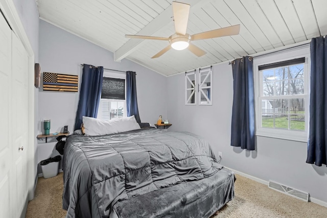 carpeted bedroom featuring vaulted ceiling with beams, ceiling fan, a closet, and wooden ceiling