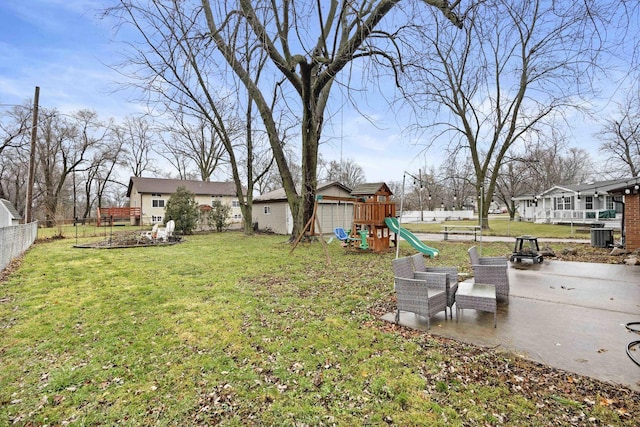 view of yard featuring a patio, a playground, and central AC