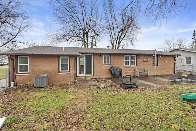 rear view of house with a patio area, a yard, and cooling unit