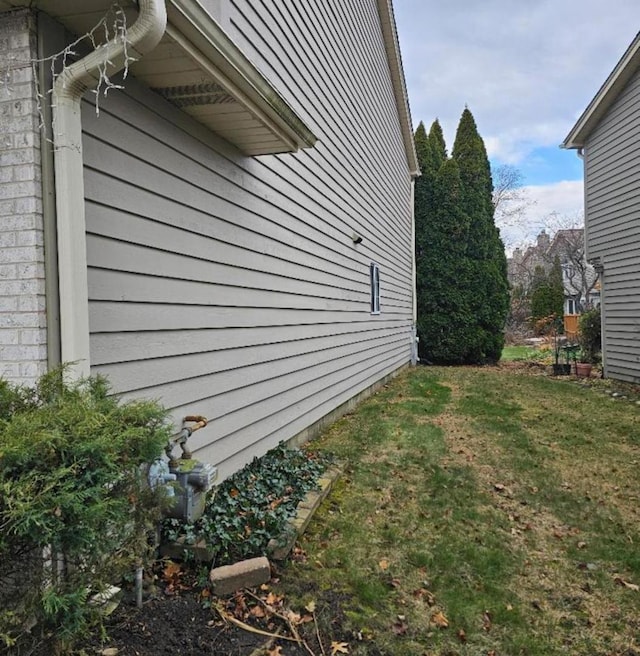 view of home's exterior with a yard