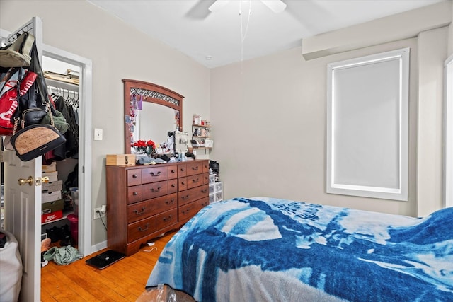 bedroom with ceiling fan, a closet, and wood-type flooring