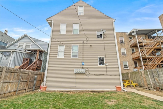 view of side of home with a yard