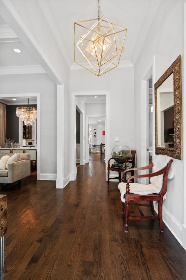 corridor featuring dark hardwood / wood-style flooring, an inviting chandelier, and crown molding