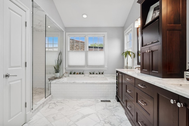 bathroom featuring vanity, lofted ceiling, and shower with separate bathtub