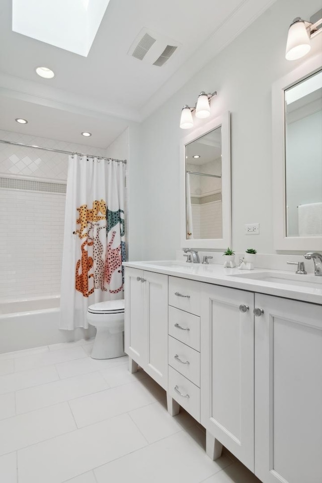 full bathroom with shower / tub combo, a skylight, tile patterned floors, vanity, and toilet