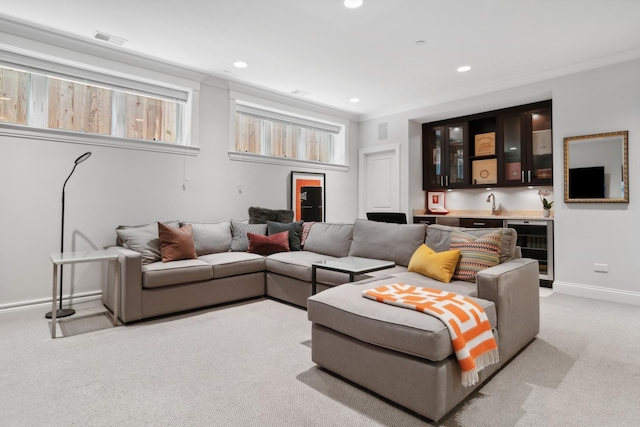 living room with wine cooler, light carpet, indoor bar, and ornamental molding