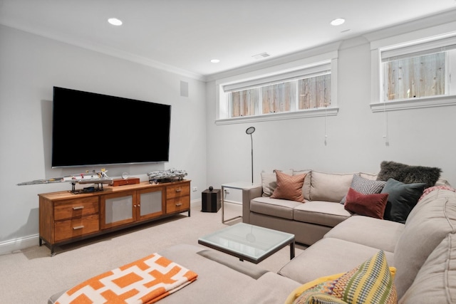 carpeted living room featuring ornamental molding