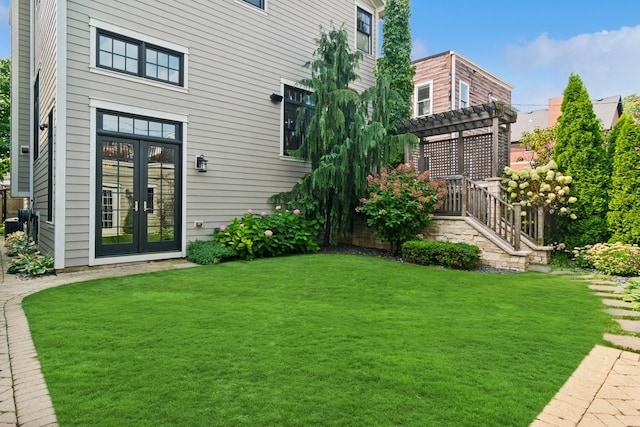 view of yard featuring a pergola and french doors