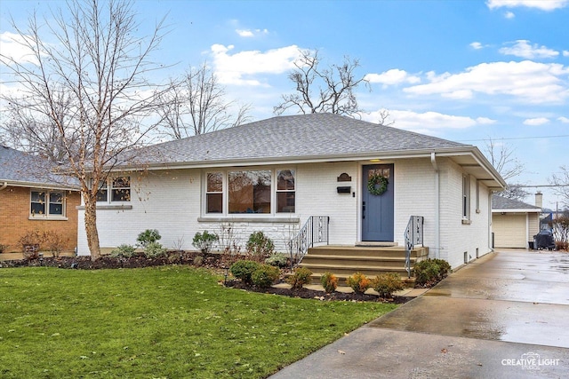 view of front facade featuring a front yard, an outbuilding, and a garage