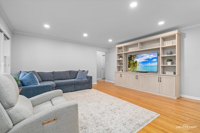 living room with crown molding and light hardwood / wood-style flooring