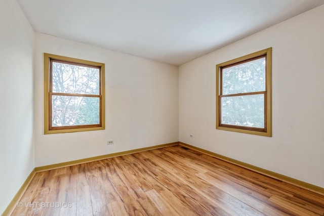 spare room featuring light hardwood / wood-style flooring