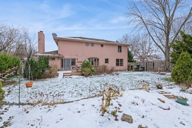 snow covered property with a wooden deck