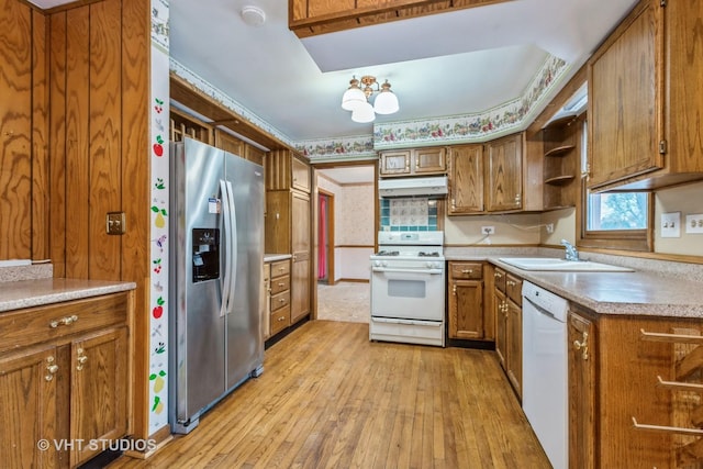 kitchen featuring crown molding, sink, white appliances, and light hardwood / wood-style flooring