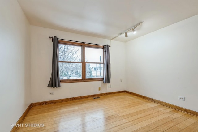 spare room with light hardwood / wood-style flooring