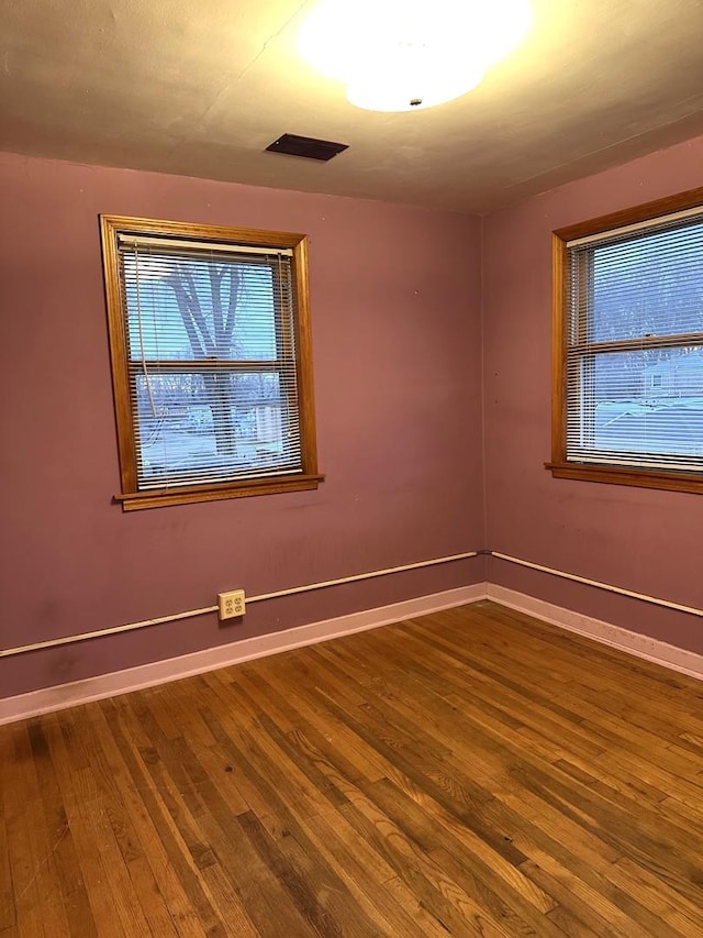 unfurnished room with hardwood / wood-style floors