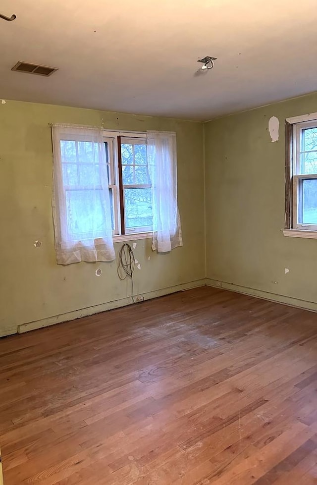 unfurnished room with light hardwood / wood-style flooring