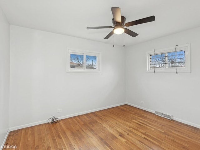 unfurnished room with hardwood / wood-style floors and ceiling fan