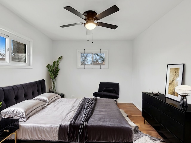 bedroom with hardwood / wood-style flooring and ceiling fan