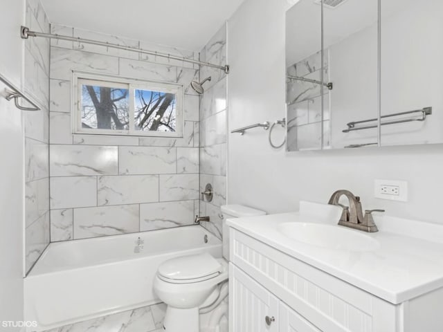 full bathroom featuring vanity, toilet, and tiled shower / bath