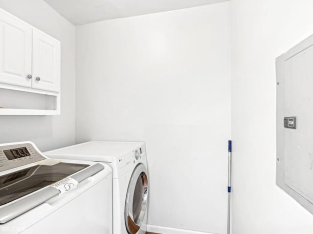 laundry room with washer and dryer and cabinets