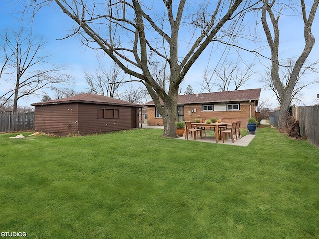 rear view of house with a yard and a patio