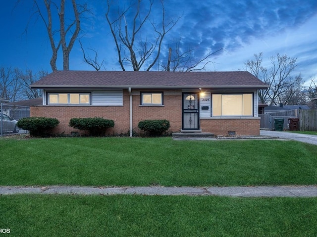 ranch-style house featuring a yard