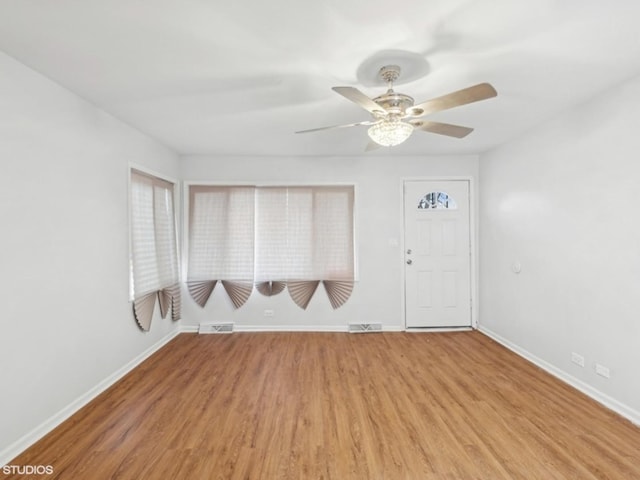 spare room with light hardwood / wood-style flooring and ceiling fan