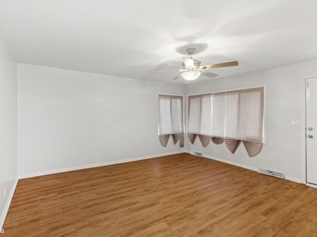 spare room with hardwood / wood-style flooring and ceiling fan