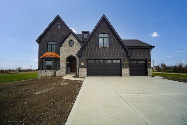 french country style house featuring a garage