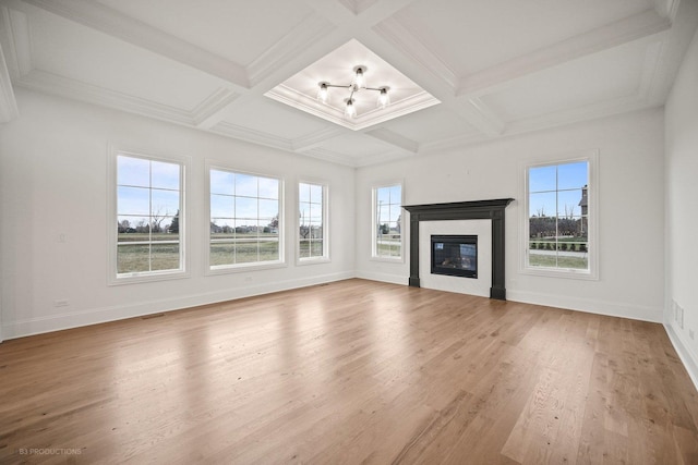 unfurnished living room featuring beam ceiling, hardwood / wood-style flooring, and coffered ceiling