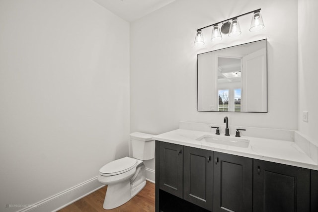 bathroom with hardwood / wood-style flooring, vanity, and toilet