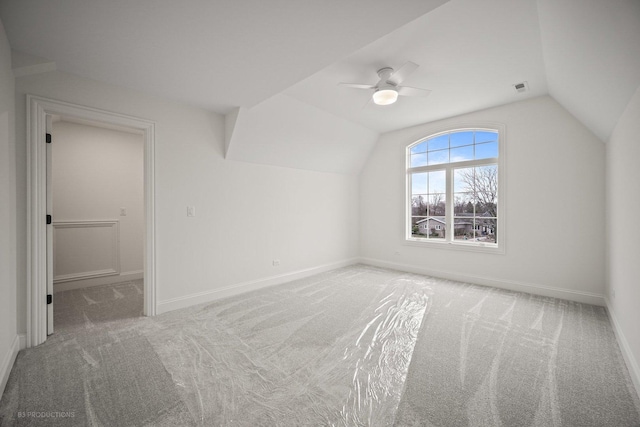 additional living space with light carpet, ceiling fan, and lofted ceiling