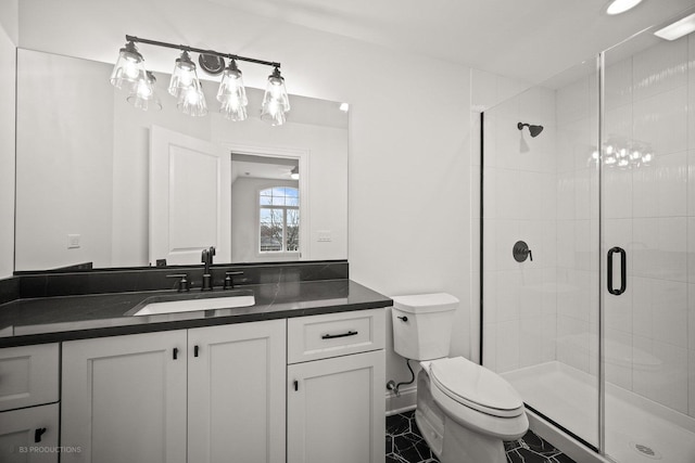 bathroom with tile patterned flooring, toilet, vanity, and walk in shower