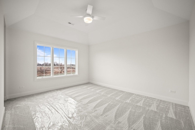 carpeted spare room featuring ceiling fan and lofted ceiling