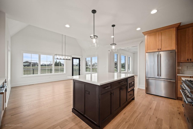 kitchen featuring a healthy amount of sunlight, appliances with stainless steel finishes, and vaulted ceiling