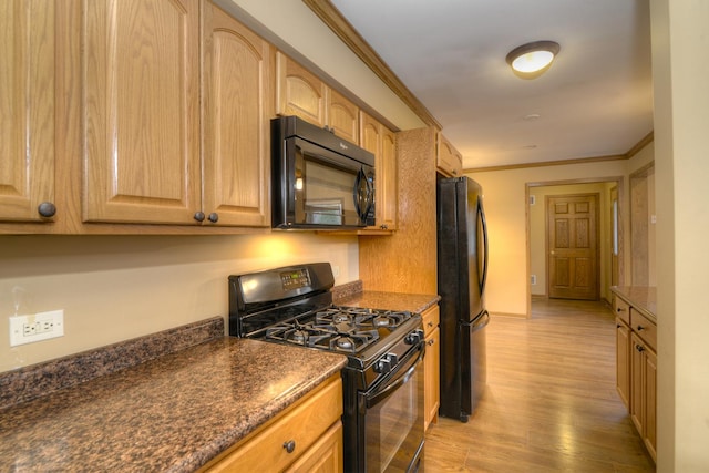 kitchen featuring black appliances, crown molding, dark stone counters, and light hardwood / wood-style flooring