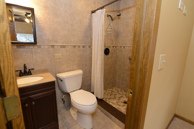 bathroom featuring tile patterned floors, vanity, toilet, and curtained shower