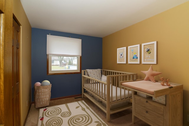 carpeted bedroom with a crib