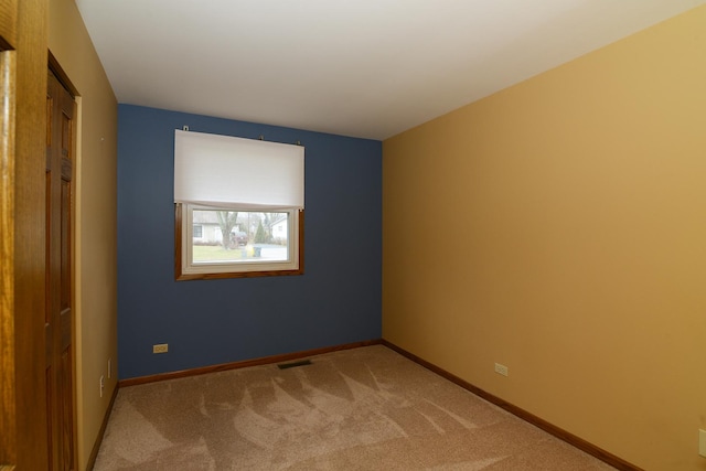 unfurnished bedroom featuring a closet and light colored carpet