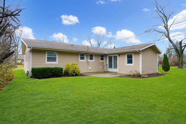 rear view of property featuring a lawn and a patio area