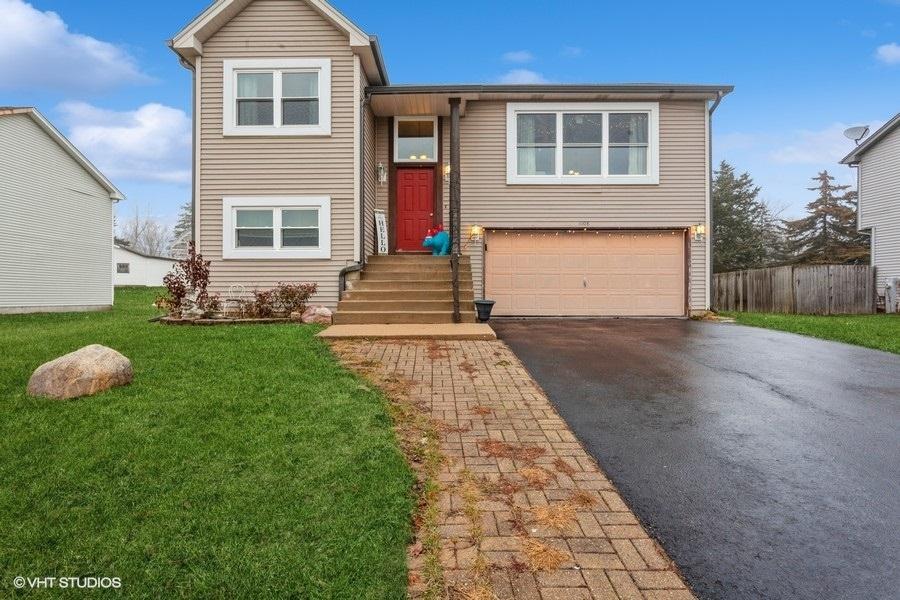 view of front of home featuring a garage and a front lawn