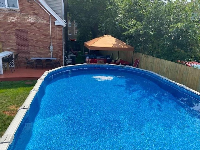 view of swimming pool featuring a gazebo and a wooden deck