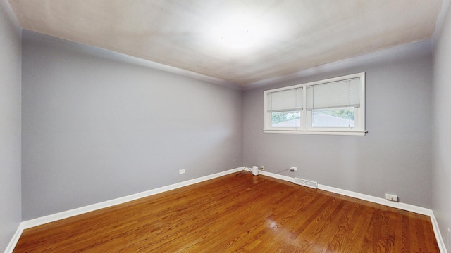 unfurnished room with wood-type flooring