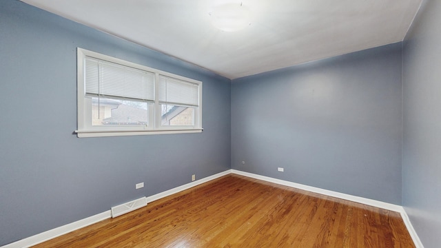 spare room with wood-type flooring