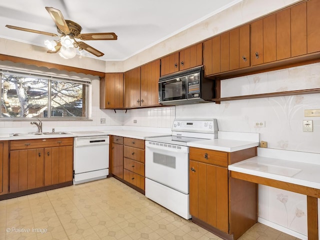 kitchen with sink, crown molding, tasteful backsplash, ceiling fan, and white appliances