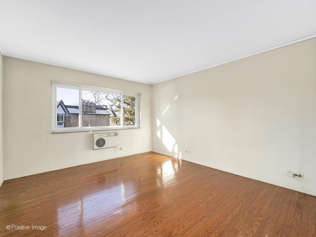 unfurnished room featuring heating unit and wood-type flooring