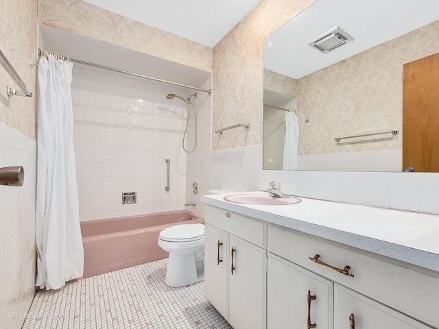 full bathroom with tile walls, tile patterned flooring, vanity, toilet, and shower / bathtub combination with curtain