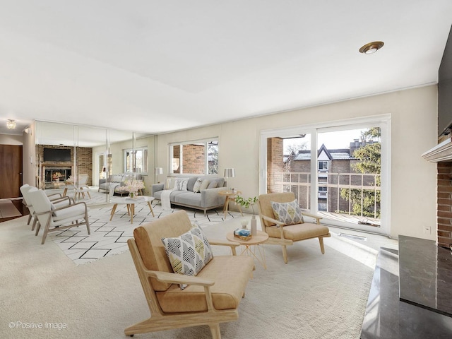 living room featuring light carpet and a fireplace